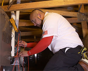 Perfect Star Heating and Air Conditioning Concord, CA Senior Comfort Adviser, Danny Mendoza servicing a client’s furnace in Brentwood, CA Heating Furnace page