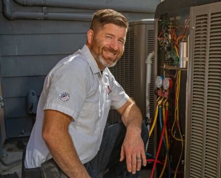 Perfect Star Heating and Air Conditioning Concord, CA Owner, Chris Donzelli servicing a client’s air conditioning unit in Brentwood, CA